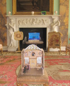 Diorama of room scene in front of real location
